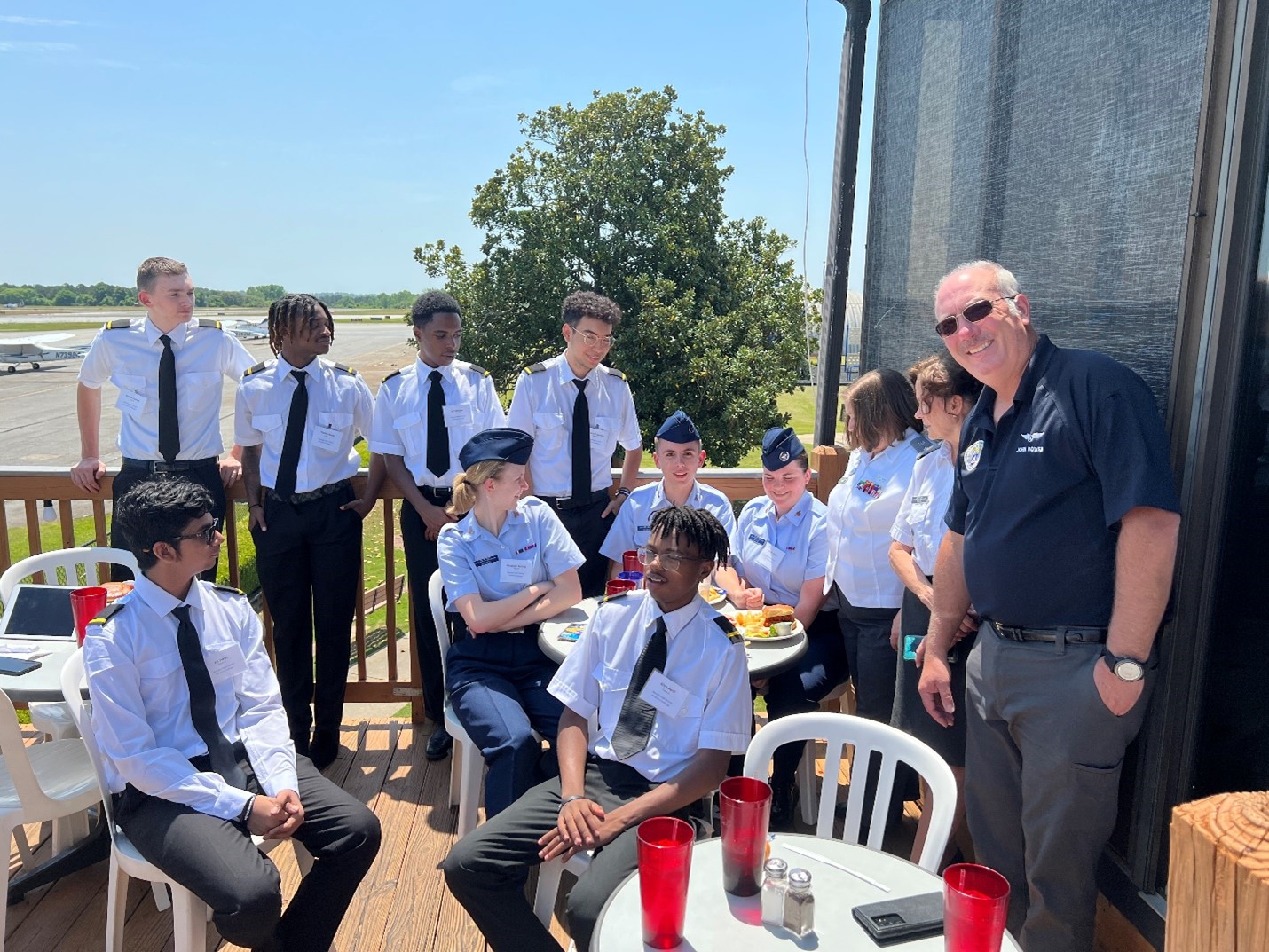 High School students sitting in uniform outside at the Downwind Restaurant